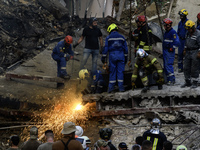 Rescuers and volunteers are working at Ohmatdyt Children's Hospital that was strongly damaged during a Russian missile strike in Kyiv, Ukrai...