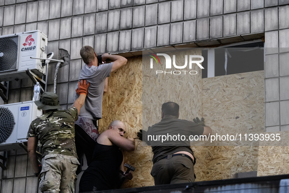 Rescuers and volunteers are working at Ohmatdyt Children's Hospital that was strongly damaged during a Russian missile strike in Kyiv, Ukrai...