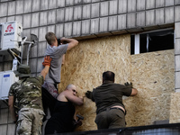 Rescuers and volunteers are working at Ohmatdyt Children's Hospital that was strongly damaged during a Russian missile strike in Kyiv, Ukrai...