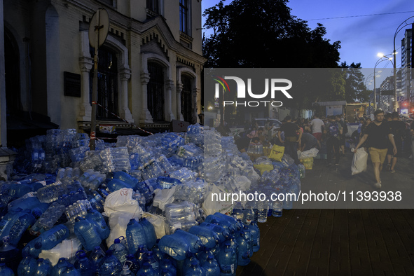 People are donating water, medicine, and food near the site of a missile attack on Ohmatdyt Children's Hospital, which is strongly damaged d...