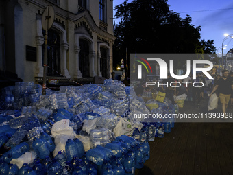 People are donating water, medicine, and food near the site of a missile attack on Ohmatdyt Children's Hospital, which is strongly damaged d...