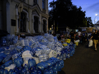 People are donating water, medicine, and food near the site of a missile attack on Ohmatdyt Children's Hospital, which is strongly damaged d...