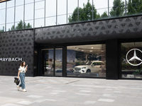 A citizen is passing the Mercedes-Maybach City Brand Center at the BFC Bund Financial Center in Huangpu District in Shanghai, China, on July...