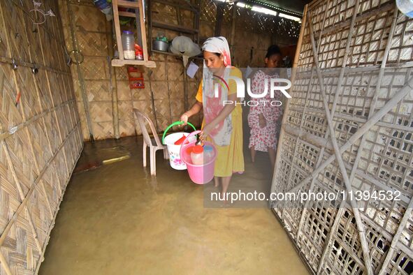 Women are staying inside their flooded house after heavy rainfall in Nagaon district of Assam, India, on July 9, 2024. 