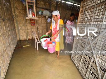 Women are staying inside their flooded house after heavy rainfall in Nagaon district of Assam, India, on July 9, 2024. (