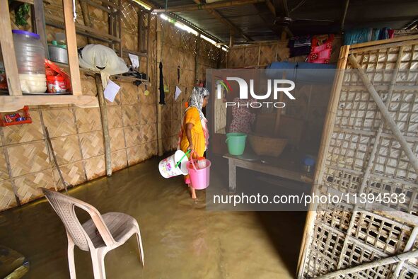 Women are staying inside their flooded house after heavy rainfall in Nagaon district of Assam, India, on July 9, 2024. 