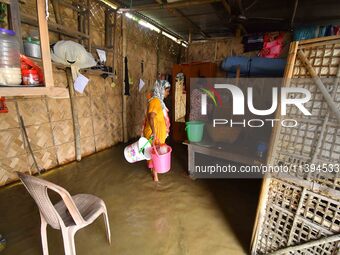 Women are staying inside their flooded house after heavy rainfall in Nagaon district of Assam, India, on July 9, 2024. (