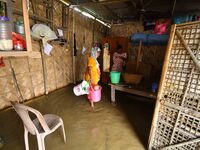 Women are staying inside their flooded house after heavy rainfall in Nagaon district of Assam, India, on July 9, 2024. (