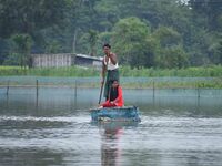 A man is rowing a makeshift raft on floodwater near his house in Nagaon district of Assam, India, on July 9, 2024. (