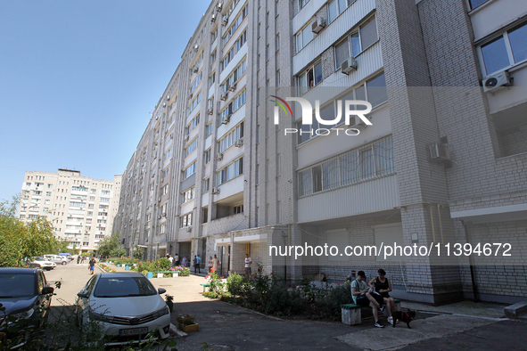 Residents are staying outside an apartment block damaged by the Russian missile attack in Dnipro, Ukraine, on July 8, 2024. NO USE RUSSIA. N...