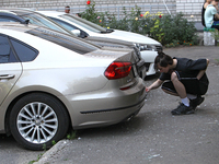 A young man is examining a car outside an apartment block damaged by the Russian missile attack in Dnipro, Ukraine, on July 8, 2024. NO USE...