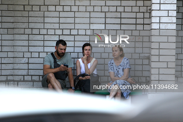 Residents are staying outside an apartment block damaged by the Russian missile attack in Dnipro, Ukraine, on July 8, 2024. NO USE RUSSIA. N...