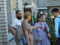 Residents are staying outside an apartment block damaged by the Russian missile attack in Dnipro, Ukraine, on July 8, 2024. NO USE RUSSIA. N...