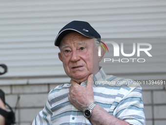 An elderly man is speaking to the press outside an apartment block damaged by the Russian missile attack in Dnipro, Ukraine, on July 8, 2024...