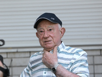 An elderly man is speaking to the press outside an apartment block damaged by the Russian missile attack in Dnipro, Ukraine, on July 8, 2024...