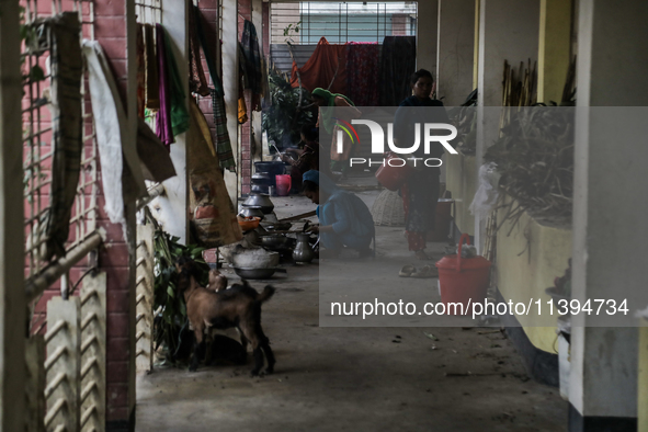 Women are cooking at a temporary flood shelter center in Jamalpur, Bangladesh, on July 9, 2024. 