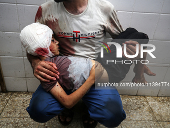 (EDITOR'S NOTE: Image depicts death) A Palestinian father is carrying the body of his son who was killed in an Israeli strike, amid the Isra...