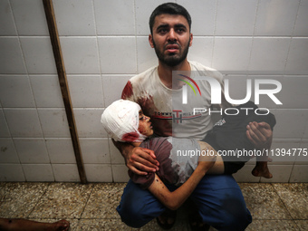 (EDITOR'S NOTE: Image depicts death) A Palestinian father is carrying the body of his son who was killed in an Israeli strike, amid the Isra...