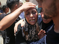 People are crying near the bodies of Palestinians killed in Israeli strikes, amid the Israel-Hamas conflict, at Al-Aqsa Martyrs Hospital in...