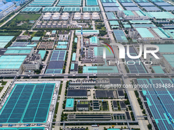 A corner of the rooftop distributed photovoltaic power generation project of Hengli (Nantong) Industrial Park is being shown in Tongzhou dis...