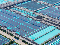 A corner of the rooftop distributed photovoltaic power generation project of Hengli (Nantong) Industrial Park is being shown in Tongzhou dis...