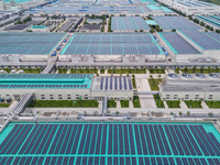 A corner of the rooftop distributed photovoltaic power generation project of Hengli (Nantong) Industrial Park is being shown in Tongzhou dis...