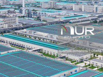 A corner of the rooftop distributed photovoltaic power generation project of Hengli (Nantong) Industrial Park is being shown in Tongzhou dis...