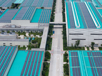 A corner of the rooftop distributed photovoltaic power generation project of Hengli (Nantong) Industrial Park is being shown in Tongzhou dis...