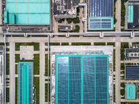 A corner of the rooftop distributed photovoltaic power generation project of Hengli (Nantong) Industrial Park is being shown in Tongzhou dis...