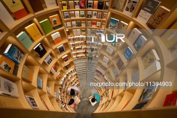 Children are reading at the Book? inside reading space in Hefei, China, on July 9, 2024. 