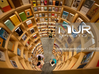 Children are reading at the Book? inside reading space in Hefei, China, on July 9, 2024. (