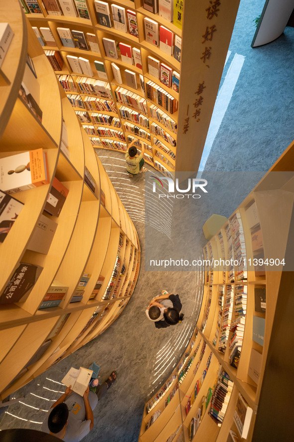 Children are reading at the Book? inside reading space in Hefei, China, on July 9, 2024. 