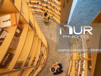 Children are reading at the Book? inside reading space in Hefei, China, on July 9, 2024. (