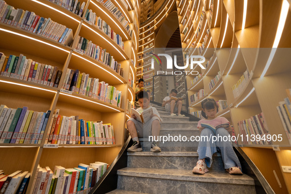 Children are reading at the Book? inside reading space in Hefei, China, on July 9, 2024. 