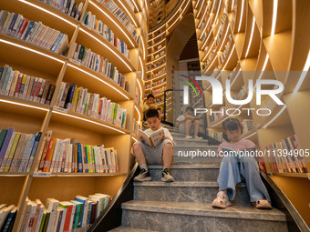 Children are reading at the Book? inside reading space in Hefei, China, on July 9, 2024. (