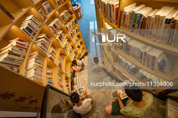 Children are reading at the Book? inside reading space in Hefei, China, on July 9, 2024. 