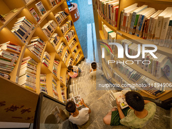 Children are reading at the Book? inside reading space in Hefei, China, on July 9, 2024. (