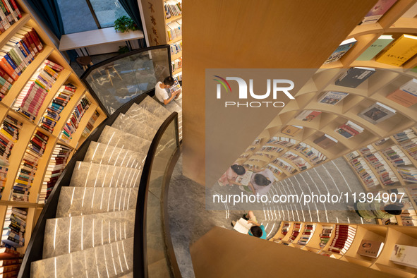 Children are reading at the Book? inside reading space in Hefei, China, on July 9, 2024. 