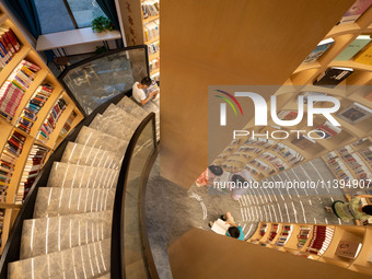 Children are reading at the Book? inside reading space in Hefei, China, on July 9, 2024. (