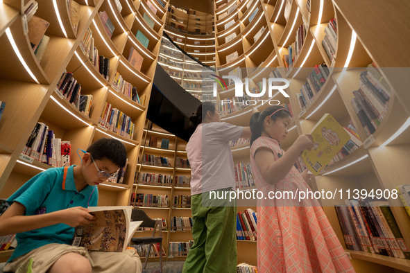 Children are reading at the Book? inside reading space in Hefei, China, on July 9, 2024. 