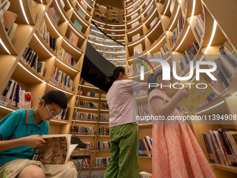 Children are reading at the Book? inside reading space in Hefei, China, on July 9, 2024. (