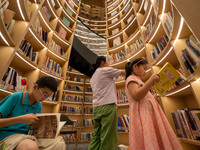 Children are reading at the Book? inside reading space in Hefei, China, on July 9, 2024. (