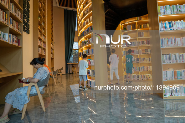 Children are reading at the Book? inside reading space in Hefei, China, on July 9, 2024. 