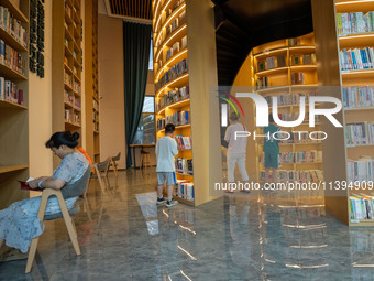 Children are reading at the Book? inside reading space in Hefei, China, on July 9, 2024. (