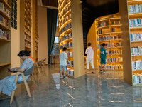 Children are reading at the Book? inside reading space in Hefei, China, on July 9, 2024. (