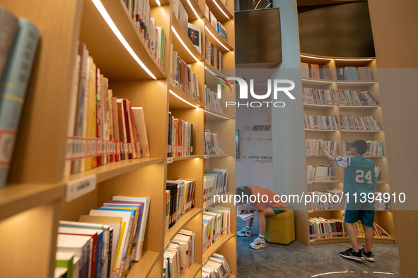 Children are reading at the Book? inside reading space in Hefei, China, on July 9, 2024. 