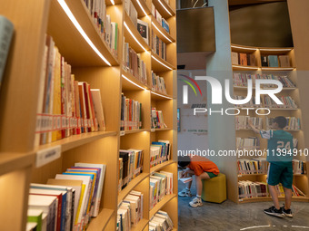 Children are reading at the Book? inside reading space in Hefei, China, on July 9, 2024. (