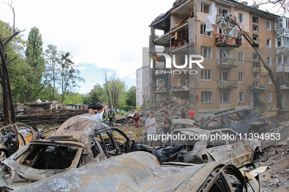 Burnt-out cars are being pictured at a five-storey apartment block in the Holosiivskyi district destroyed by the Russian missile attack in K...