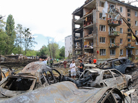 Burnt-out cars are being pictured at a five-storey apartment block in the Holosiivskyi district destroyed by the Russian missile attack in K...