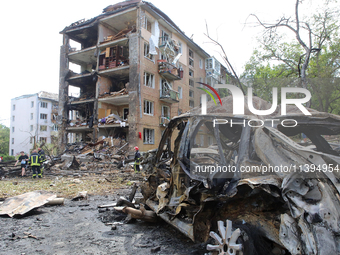 A burnt-out car is being pictured at a five-storey apartment block in the Holosiivskyi district destroyed by the Russian missile attack in K...